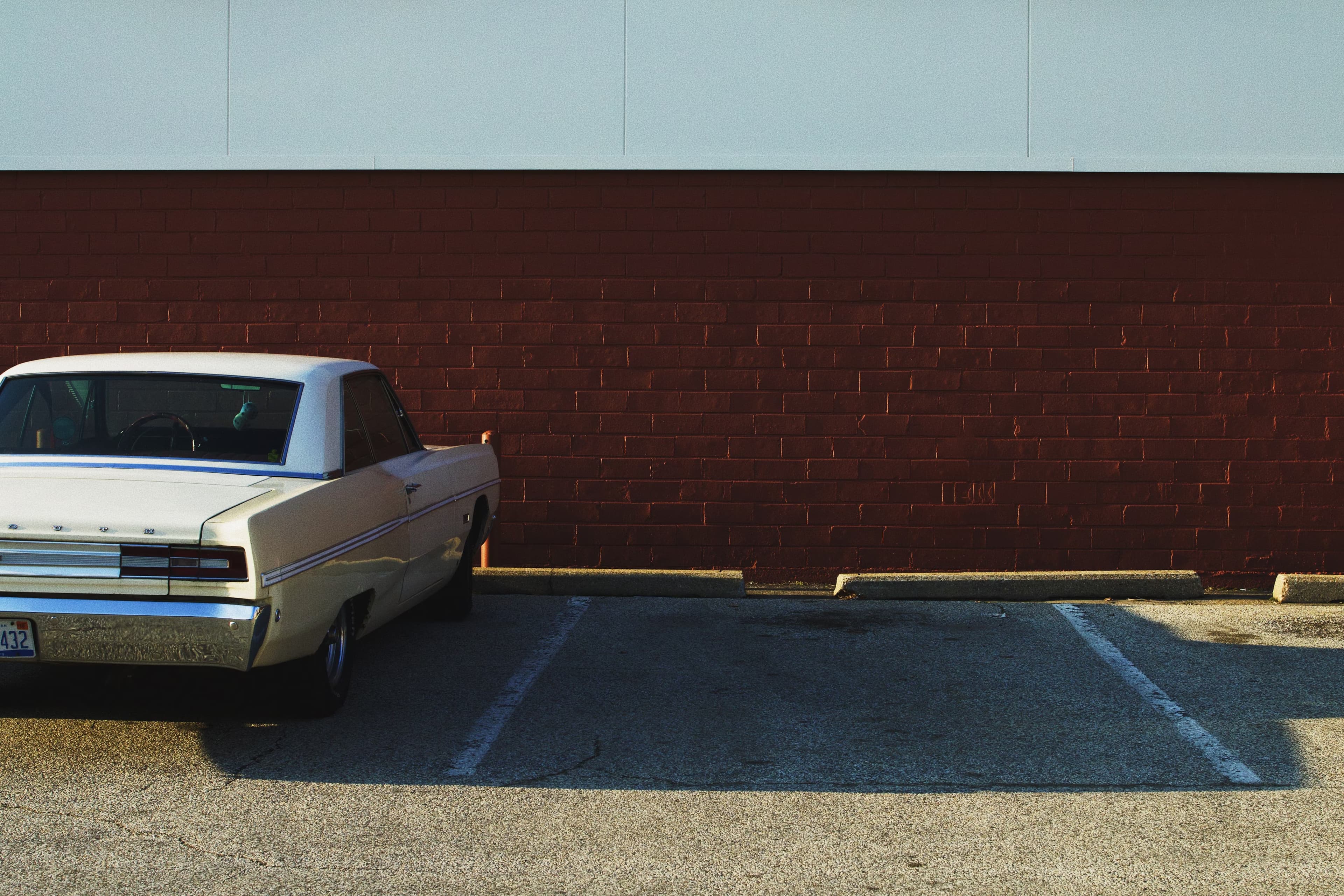 a parking spot with a beautiful car park on the left