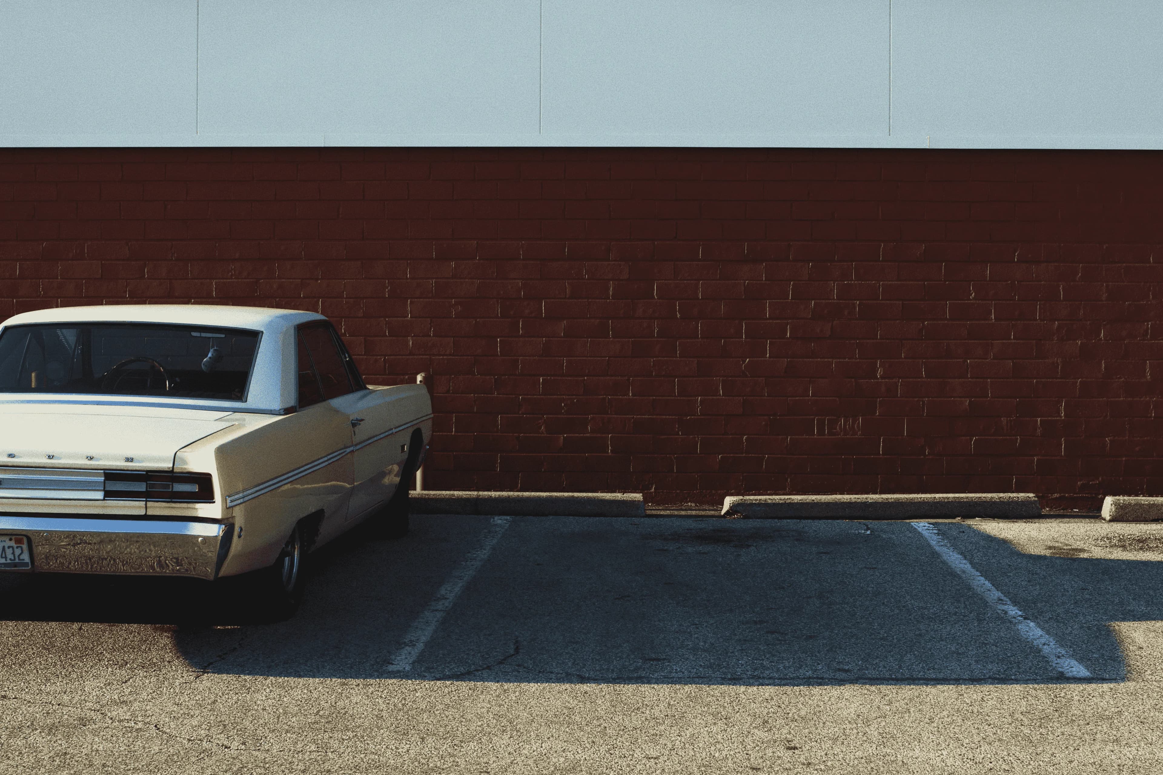 a parking spot with a beautiful car park on the left